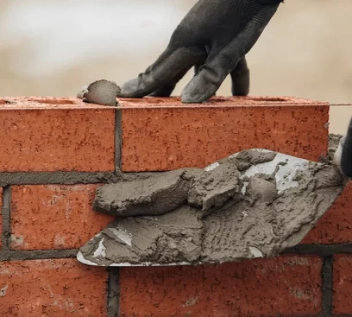 close-hands-bricklayer-laying-mortar-600nw-2477499301