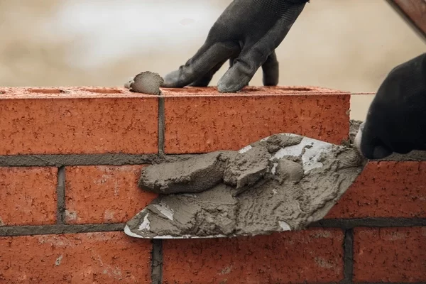 close-hands-bricklayer-laying-mortar-600nw-2477499301